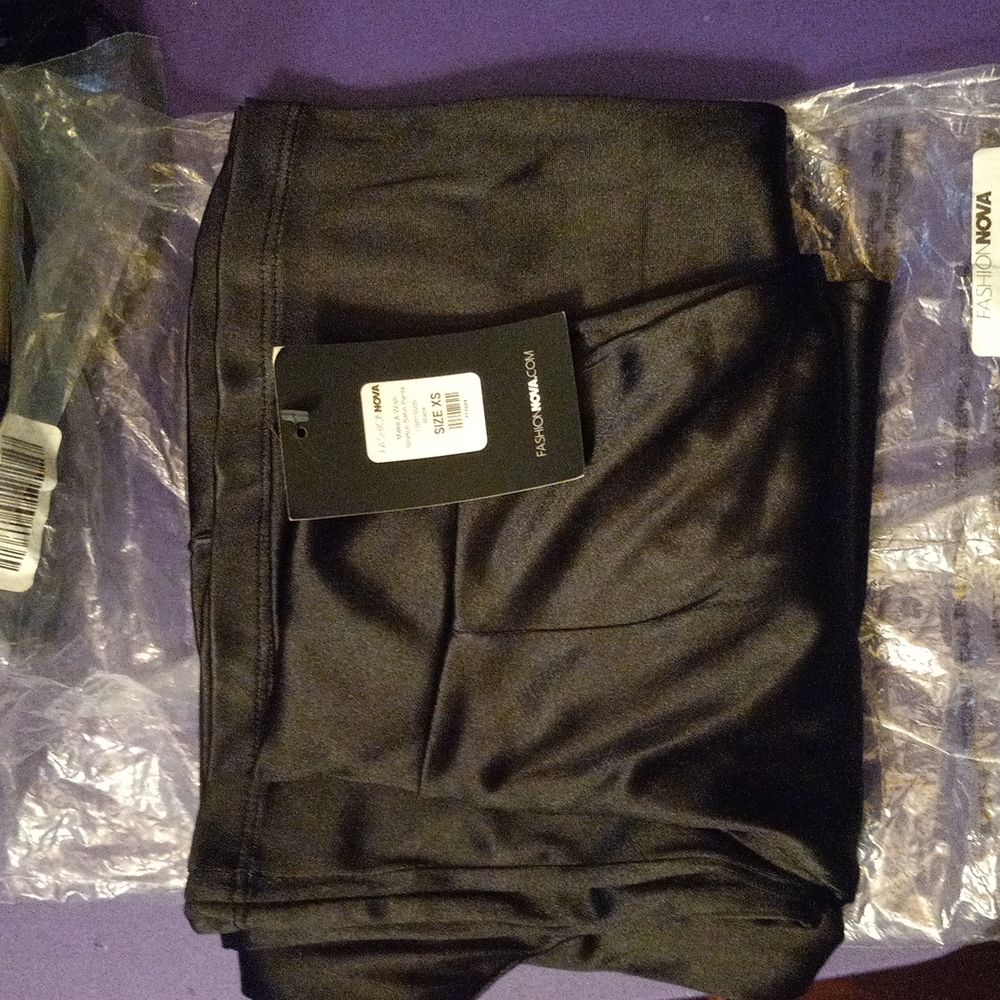 Fashion Nova black satin bell bottom pants.